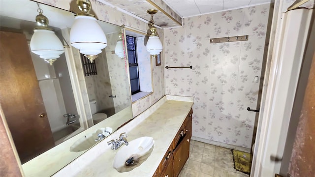 bathroom featuring vanity, crown molding, and toilet