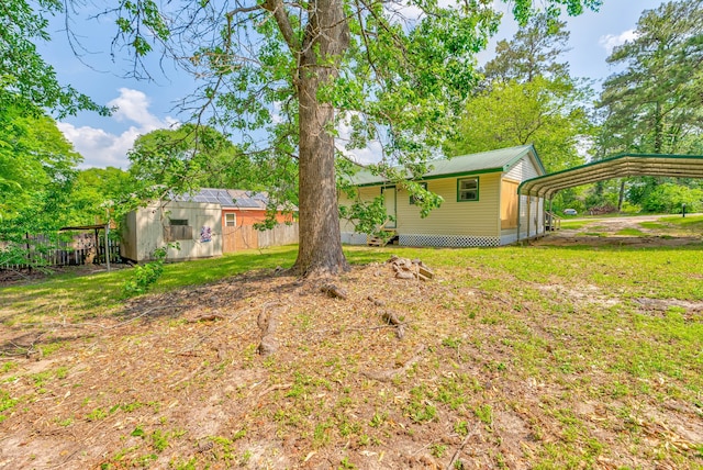 view of yard with a shed and a carport