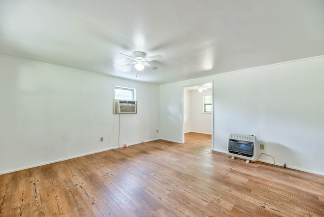 spare room featuring cooling unit, heating unit, ceiling fan, and light hardwood / wood-style floors