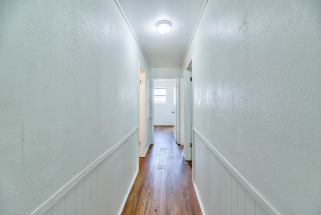 hall with hardwood / wood-style floors and ornamental molding