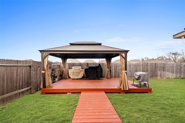 deck featuring a gazebo and a lawn