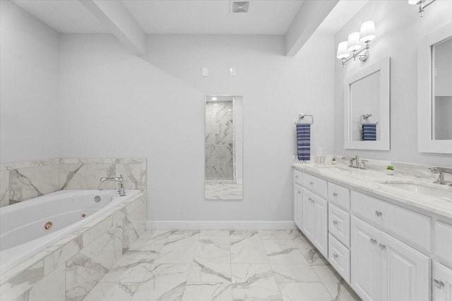 bathroom featuring a tub with jets, a sink, visible vents, and baseboards