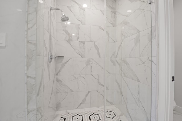 details featuring a marble finish shower