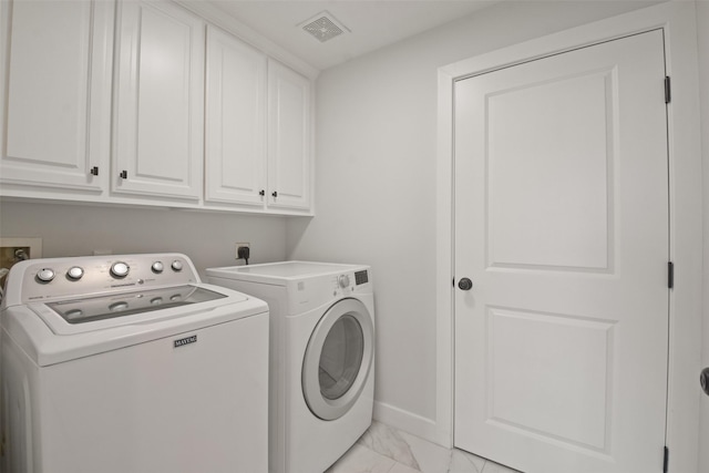 laundry area featuring marble finish floor, washer and clothes dryer, visible vents, cabinet space, and baseboards