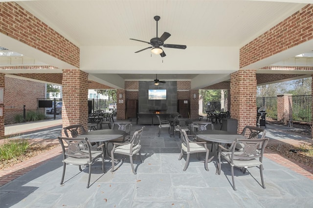 view of patio / terrace with ceiling fan, fence, and outdoor dining space