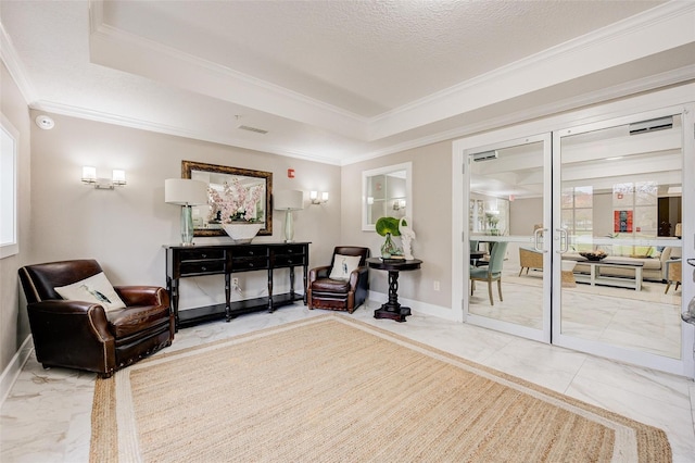 living area with ornamental molding, a tray ceiling, marble finish floor, and baseboards