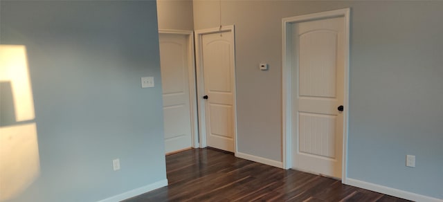 unfurnished bedroom featuring dark hardwood / wood-style flooring