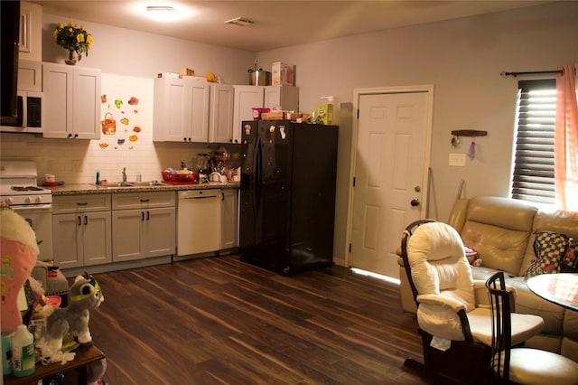 kitchen featuring dark hardwood / wood-style flooring, sink, white appliances, and white cabinets