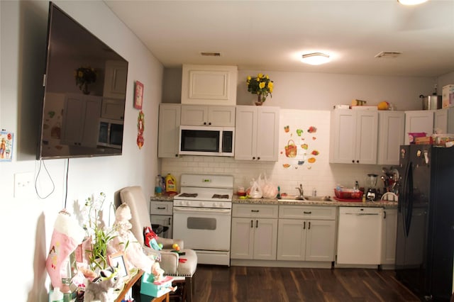 kitchen featuring tasteful backsplash, sink, white cabinets, and white appliances