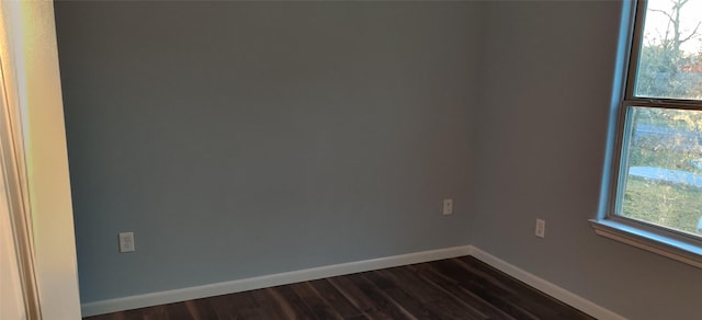 spare room featuring dark hardwood / wood-style floors