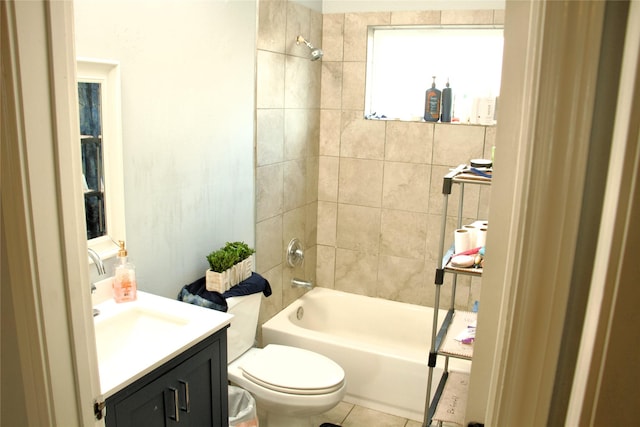 full bathroom with tiled shower / bath, vanity, toilet, and tile patterned flooring