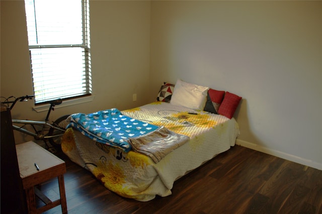 bedroom with dark wood-type flooring