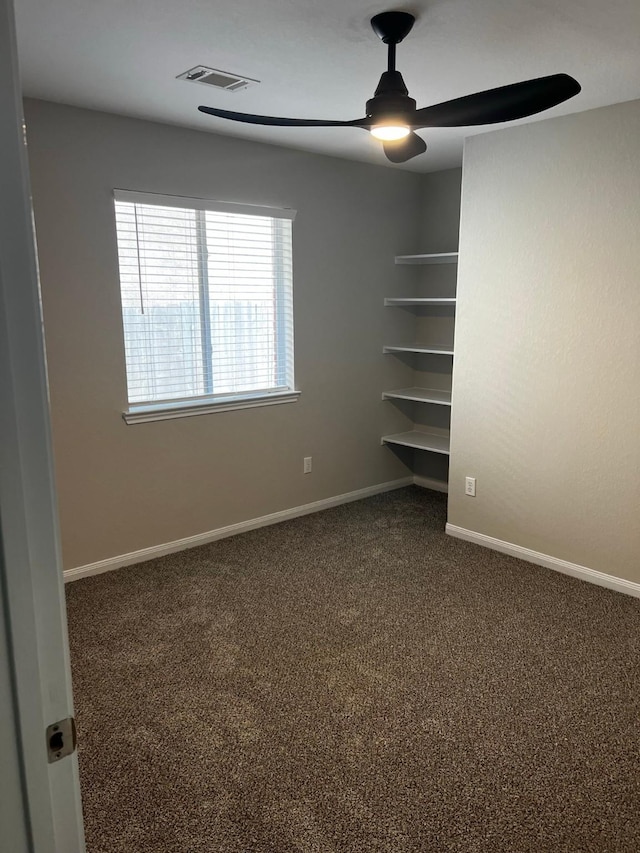 unfurnished bedroom featuring ceiling fan and dark colored carpet