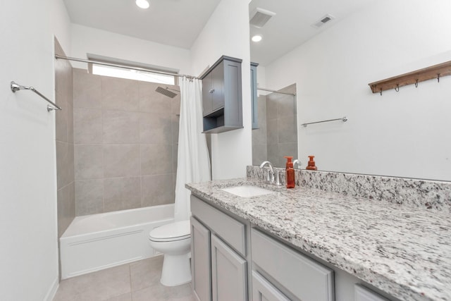 full bathroom featuring tile patterned flooring, vanity, toilet, and shower / bath combo with shower curtain