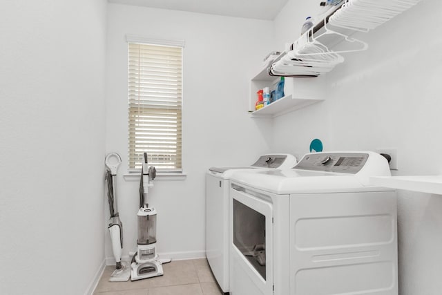 laundry area featuring light tile patterned floors and washing machine and dryer