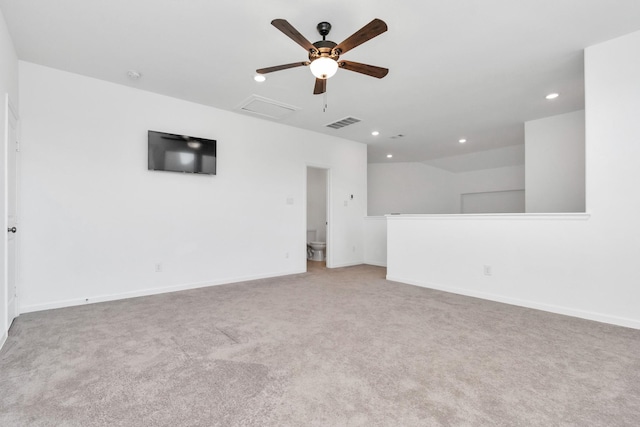 spare room featuring light colored carpet and ceiling fan