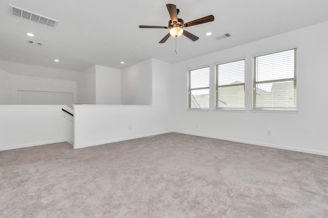 unfurnished room with light carpet and ceiling fan