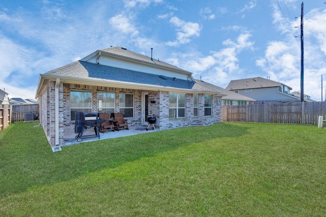 rear view of house featuring central AC, a yard, and a patio