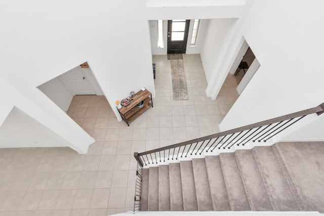 stairway featuring tile walls