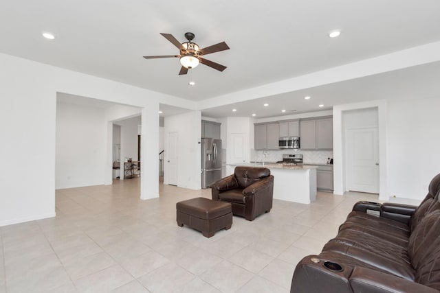 living room with light tile patterned floors and ceiling fan