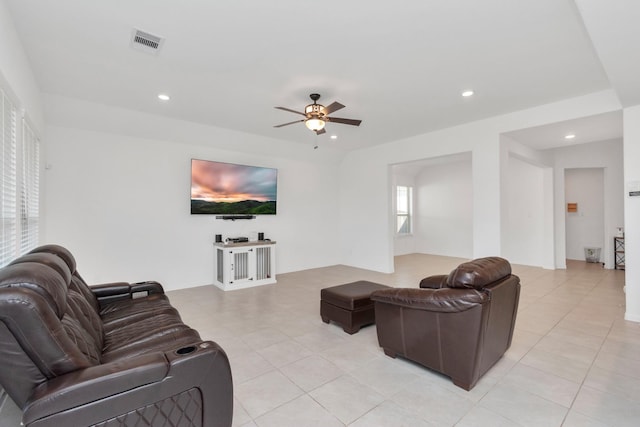 tiled living room with ceiling fan