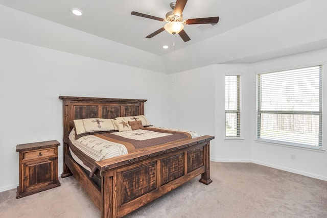 bedroom with vaulted ceiling, light carpet, and ceiling fan