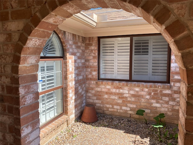 doorway to property with brick siding