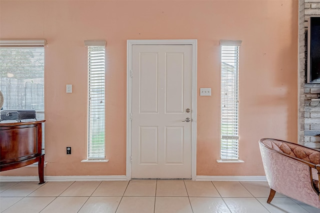 tiled foyer entrance with a healthy amount of sunlight