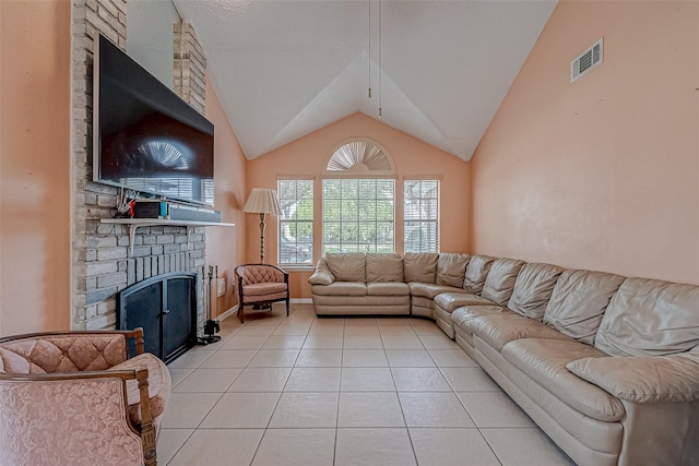 tiled living room with vaulted ceiling and a brick fireplace