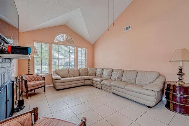 tiled living room with vaulted ceiling, a textured ceiling, and a fireplace