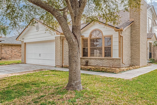 view of front of house with a garage and a front lawn