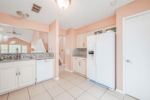 kitchen with white cabinetry, sink, backsplash, and white appliances