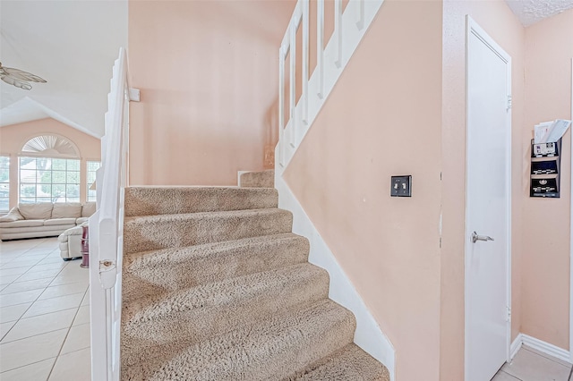 stairs featuring lofted ceiling and tile patterned floors