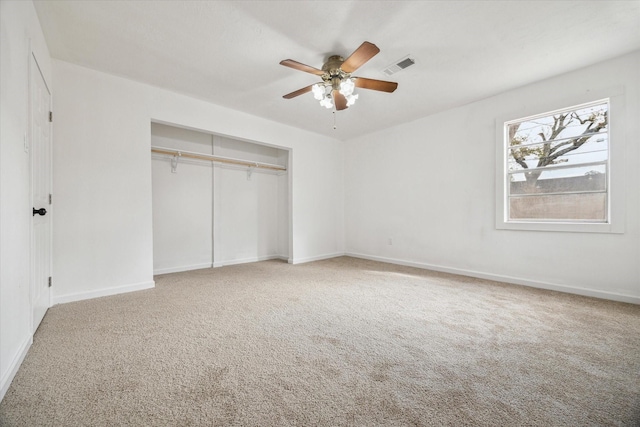 unfurnished bedroom with carpet flooring, ceiling fan, and a closet