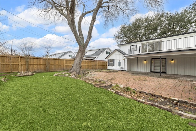 view of yard with a balcony and a patio area