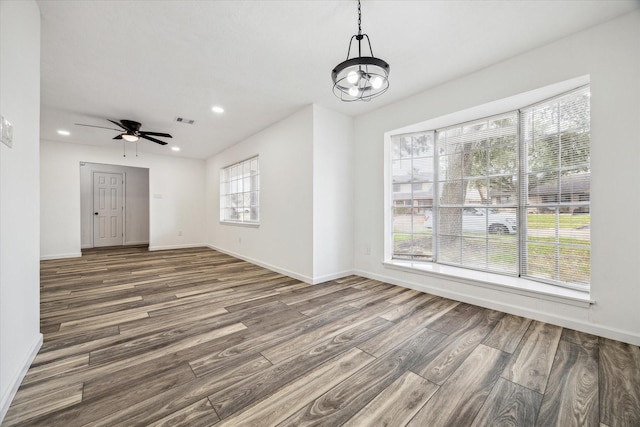 interior space with dark wood-type flooring and ceiling fan