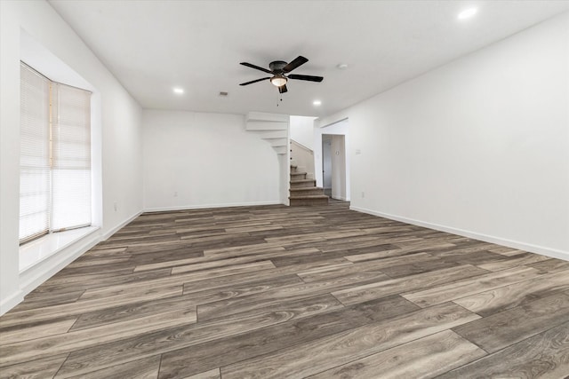 unfurnished living room featuring dark hardwood / wood-style floors and ceiling fan