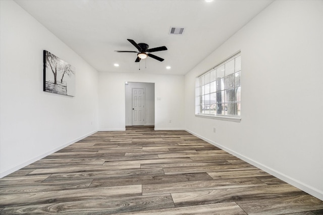 empty room featuring wood-type flooring and ceiling fan