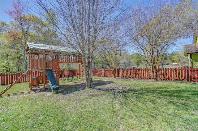 view of yard featuring a fenced backyard and a playground