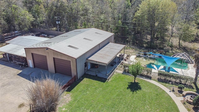 drone / aerial view featuring a wooded view