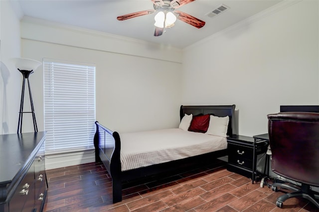 bedroom with a ceiling fan, baseboards, visible vents, crown molding, and dark wood-type flooring