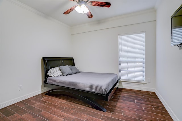 bedroom featuring baseboards, ornamental molding, ceiling fan, and wood finished floors