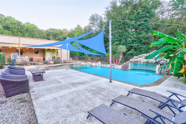 outdoor pool with a patio area and fence