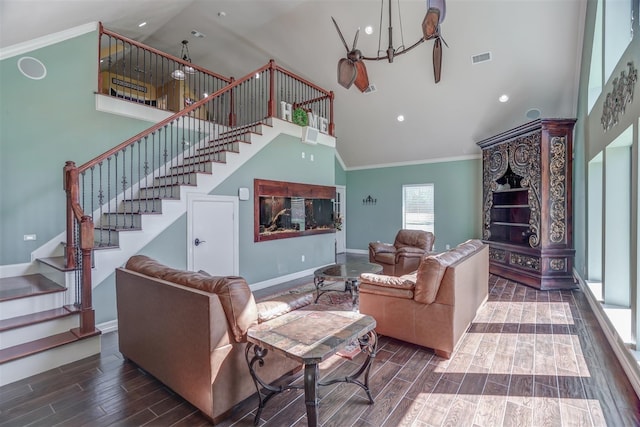 living area featuring stairway, wood finished floors, visible vents, and high vaulted ceiling