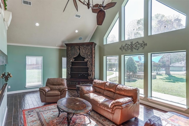 living area featuring baseboards, crown molding, visible vents, and high vaulted ceiling