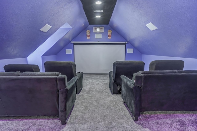 cinema featuring a textured ceiling, carpet floors, and vaulted ceiling
