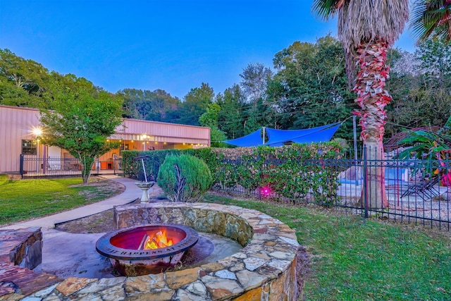 view of yard with a fire pit, a patio area, and fence