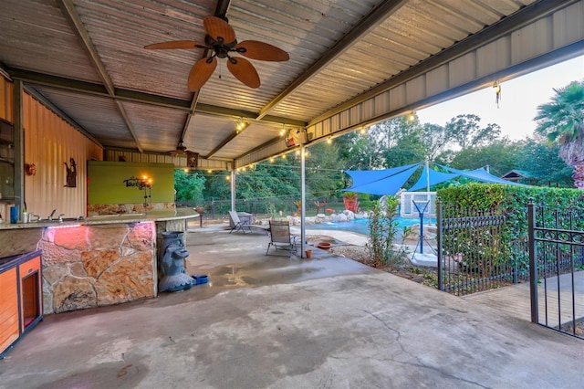 view of patio with fence and a ceiling fan