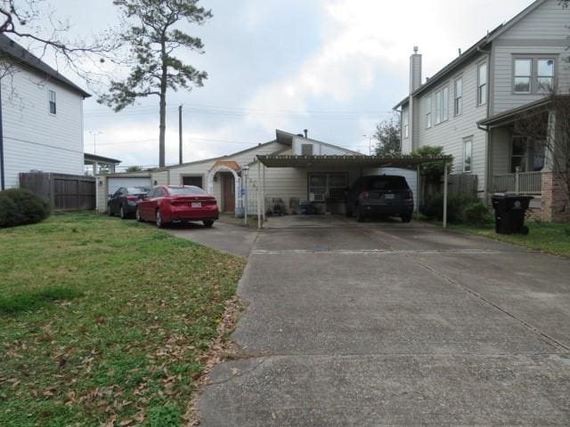 view of parking featuring a garage and a lawn