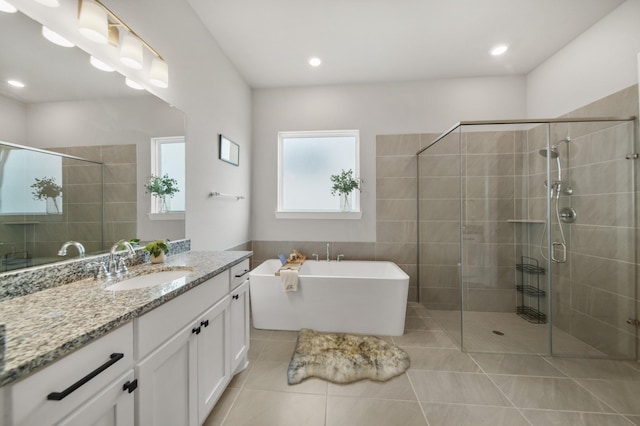 bathroom featuring vanity, tile patterned floors, and plus walk in shower